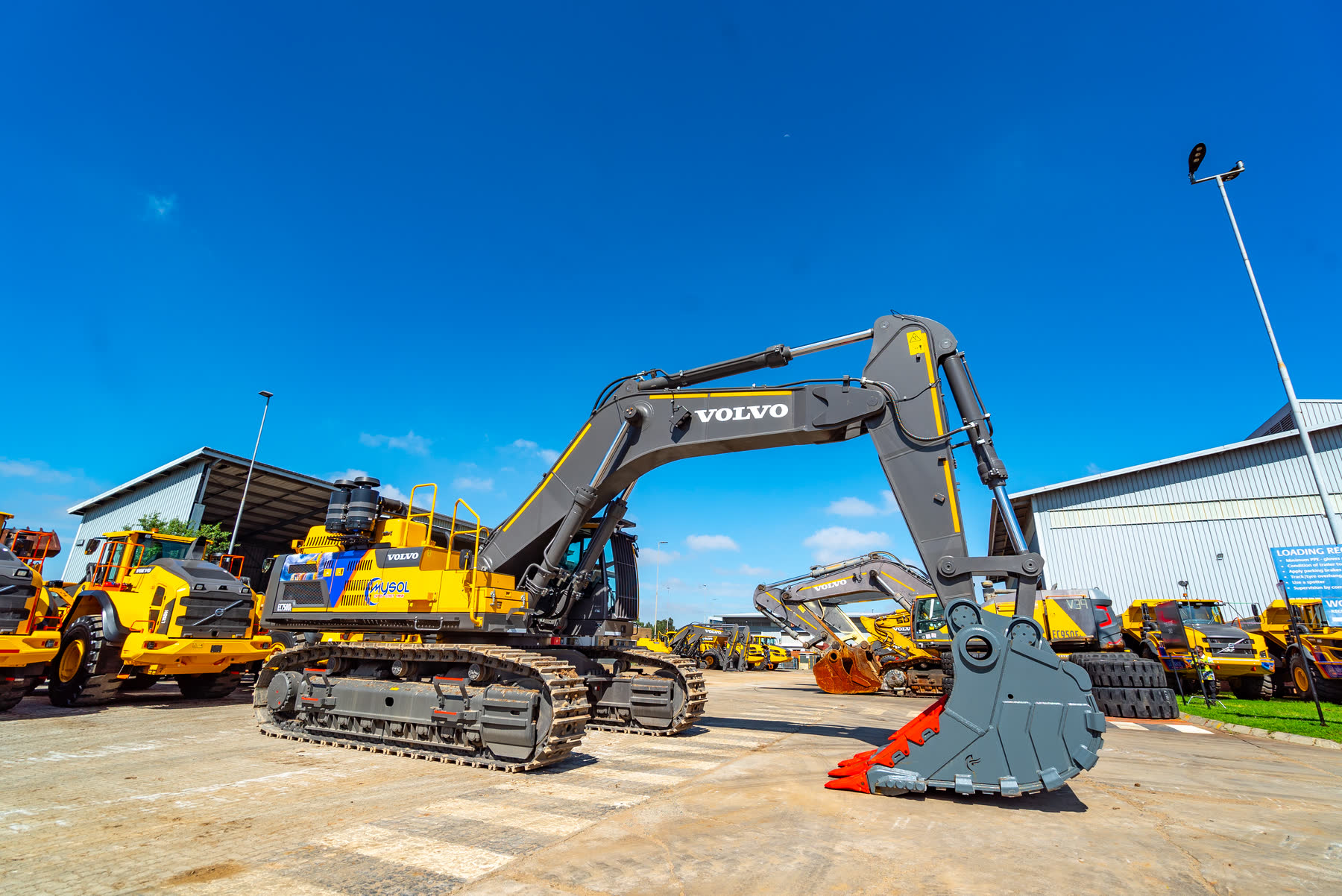 High-capacity loader loading dump truck on site.