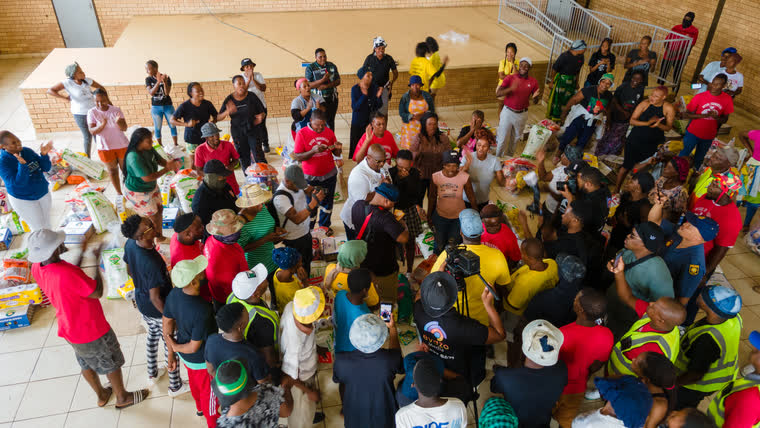 Volunteers handing out food parcels to households in need