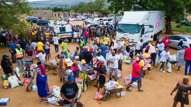 Community members gathered around the distribution vehicles