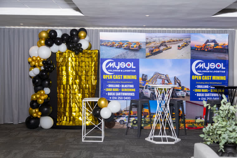 MySol Foundation event stage with branded backdrop and balloons