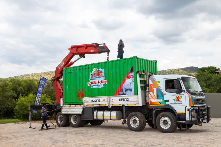 A branded container being lifted into place for a Foundation project