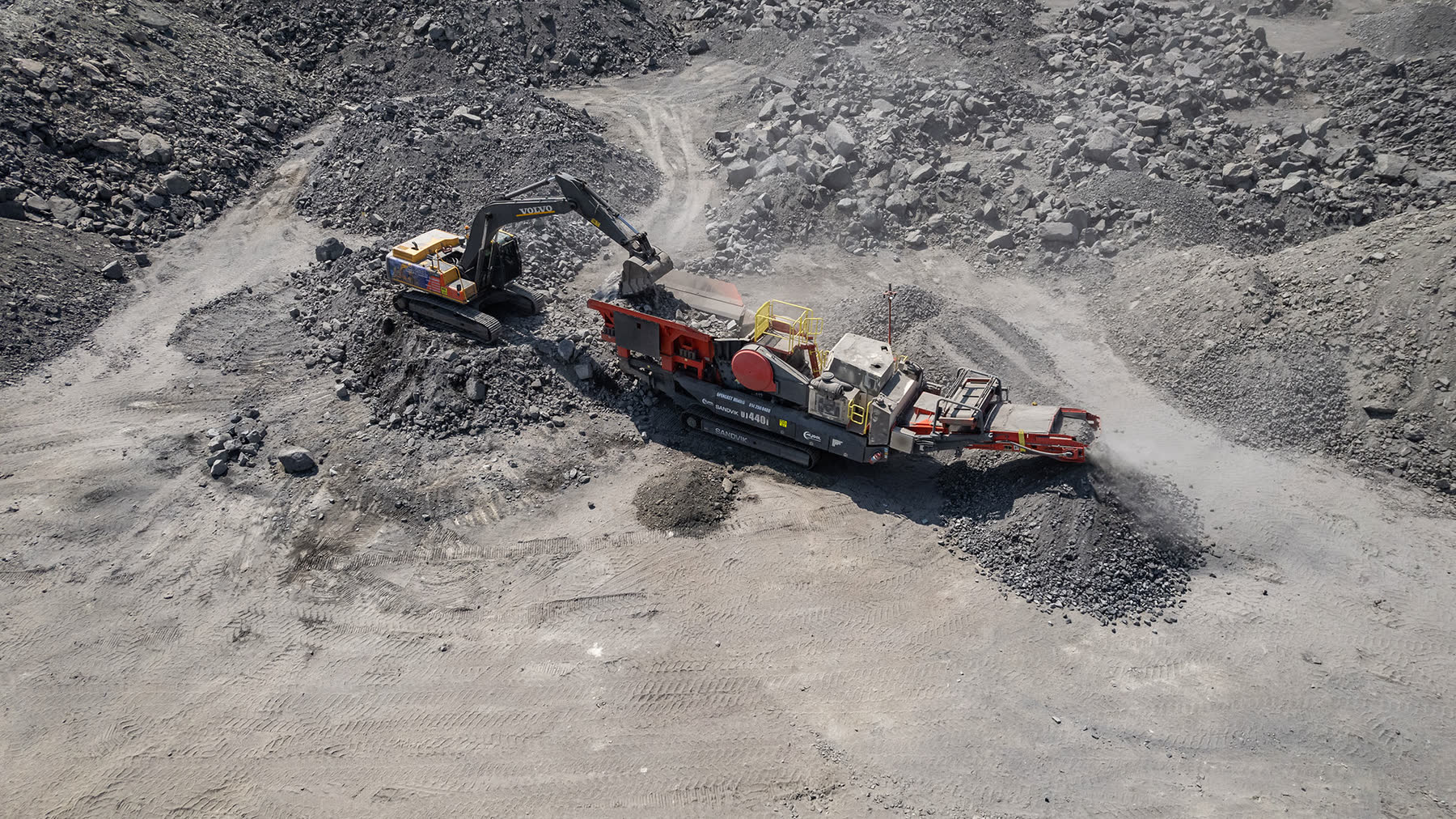 Mobile crushing and screening station active on project site.